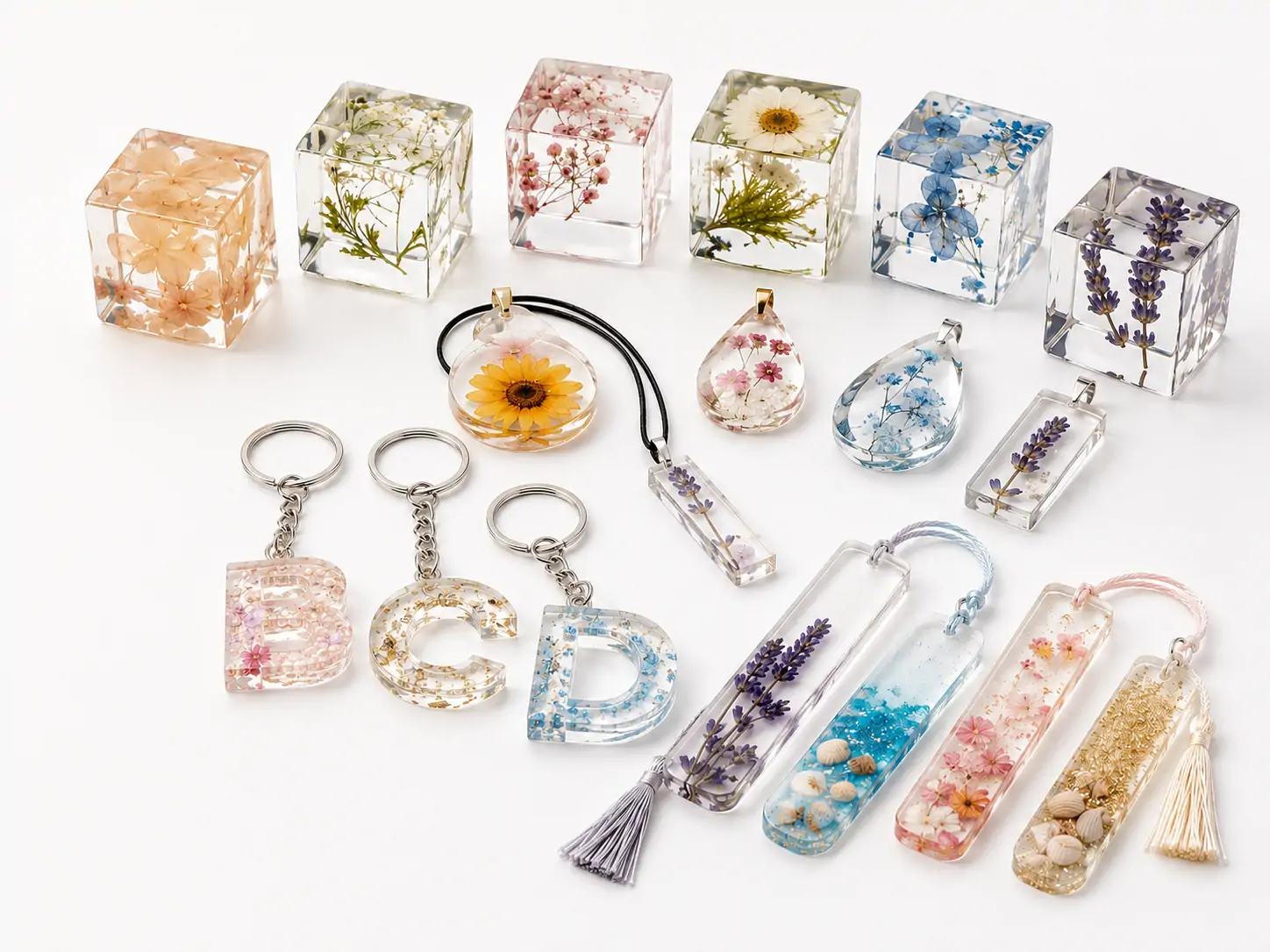 Crystal clear epoxy resin applications including flower specimens, jewelry, keychains and small decorative molded products